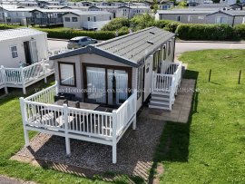 Exterior view of 2-bedroom caravan for hire at Reighton Sands – ref 54